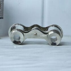 Top-down view of pocket-sized nickel binoculars, showing the shape of the bridge and the top of the focus knob.