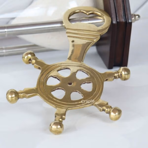 Side profile of the ship's wheel bottle opener, showing the thickness of the brass and the opener mechanism.