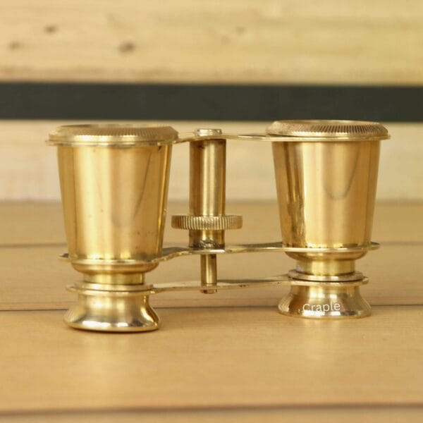 Shiny Brass Decorative Binoculars-2 Side profile of collectible shiny brass binoculars, showcasing their traditional and elegant construction.