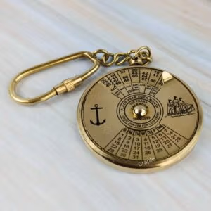 Solid brass 100-year perpetual calendar keychain with nautical anchor and ship engravings and a secure carabiner clip.