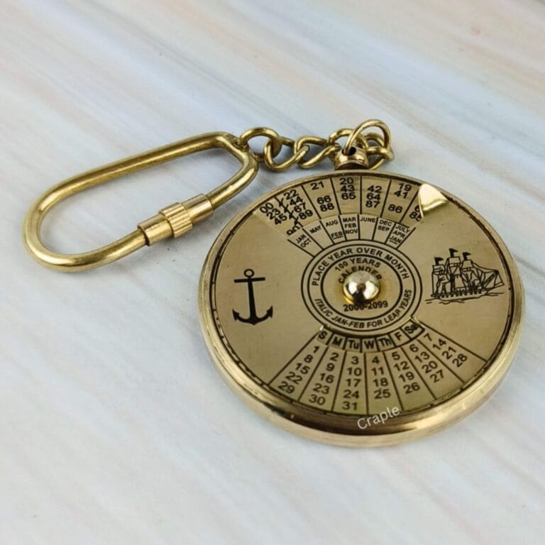 Solid brass 100-year perpetual calendar keychain with nautical anchor and ship engravings and a secure carabiner clip.