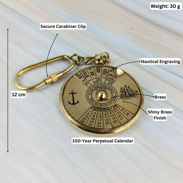 Brass calendar keychain with labeled dimensions showing 12 cm length, 30g weight, and pointing out its features.