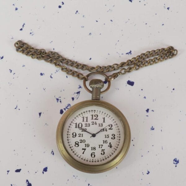 The antique brass pocket watch displayed with its full matching link chain extended.