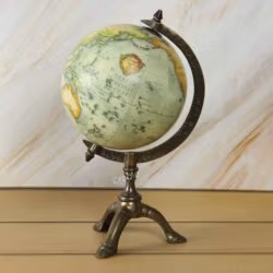 Antique world globe with a vintage map on a decorative brass tripod stand, perfect for desk or office decor.