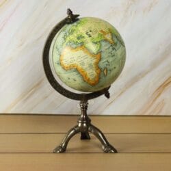The antique brass globe rotated to display the continents of Africa and Europe in detail.
