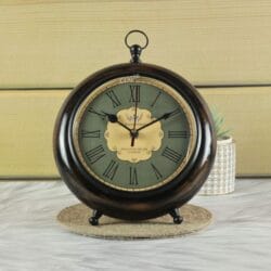 Antique wooden tabletop and hanging clock with a dark wood finish, a vintage green face, and Roman numerals.