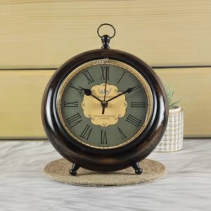 Antique wooden tabletop and hanging clock with a dark wood finish, a vintage green face, and Roman numerals.