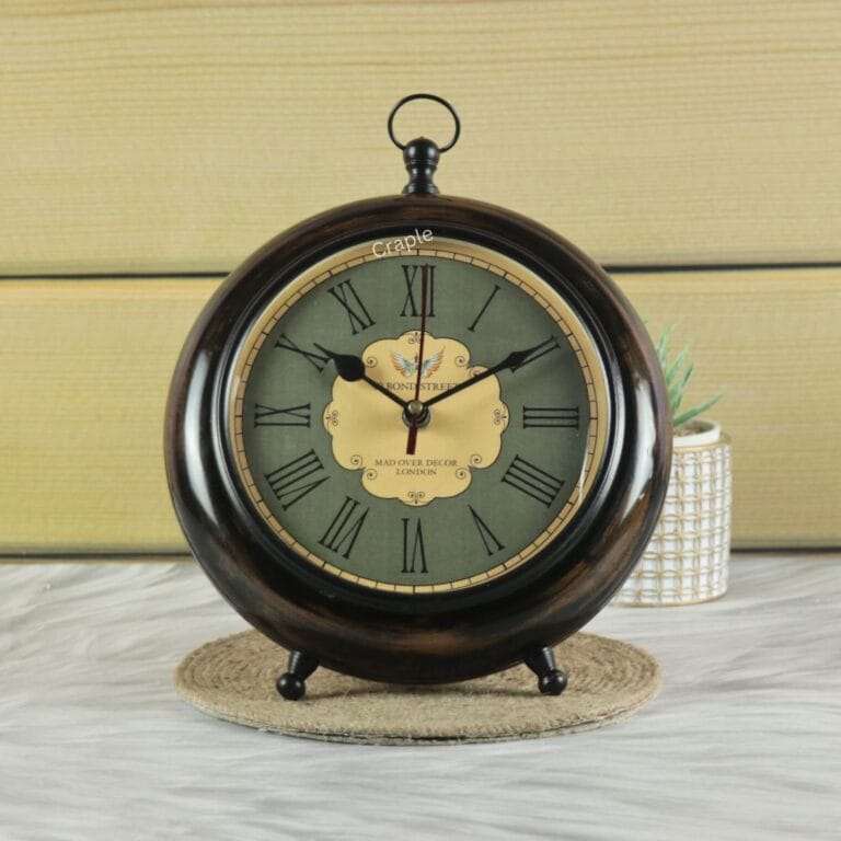 Antique wooden tabletop and hanging clock with a dark wood finish, a vintage green face, and Roman numerals.