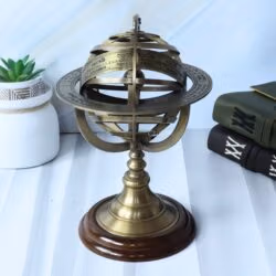Left-angled view of the tabletop brass armillary globe, showing the engraved rings and wood base.