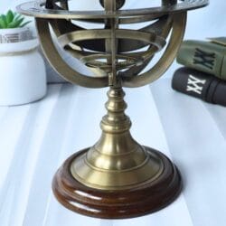 Close-up shot of the polished solid wood base and turned brass pedestal of the armillary sphere.