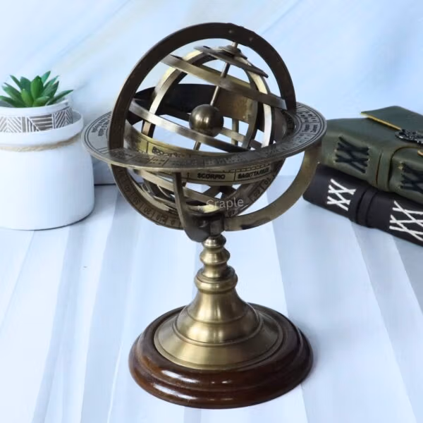 The brass and wood armillary sphere shown as a desktop accessory next to antique-style books.