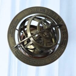 Top-down view of the brass armillary sphere highlighting the outermost zodiac ring and interlocking globes.