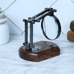Side profile of the folding desk magnifying glass, showing the detail of the black antique brass articulated arm.