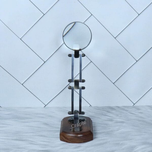 Black Folding Desk Magnifier-4 The vintage desk magnifier fully extended to its maximum height, standing on its polished wood base.