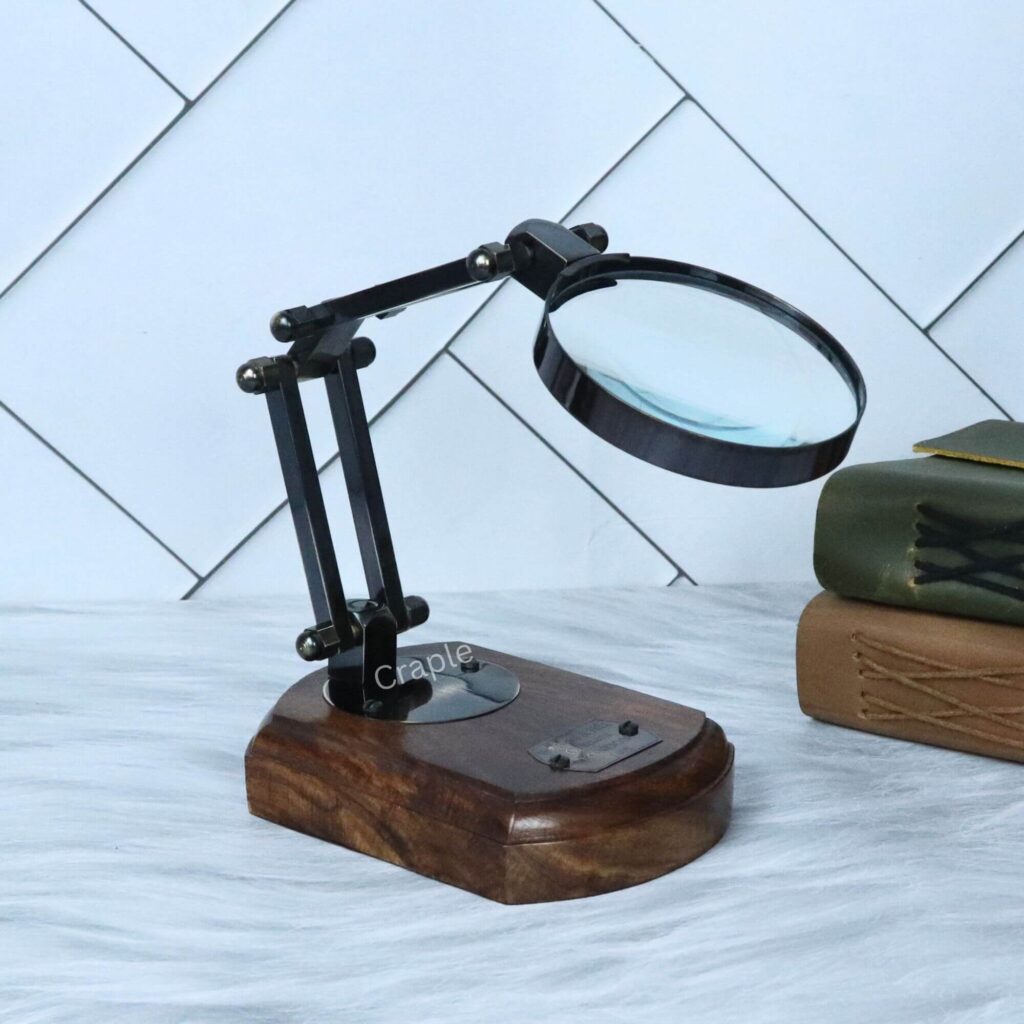 Elegant folding desk magnifier with a black antique finish and polished wood base, shown in a classic angled view.