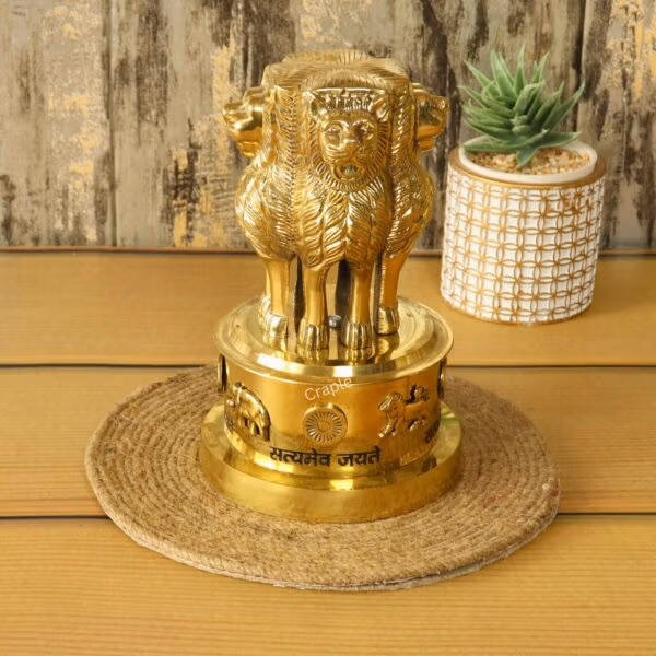 Angled side view of the brass Ashok Stambh showpiece, highlighting its polished finish and three-dimensional form.