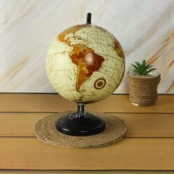 Vintage desktop globe with a black stand, rotated to show the continents of North and South America.