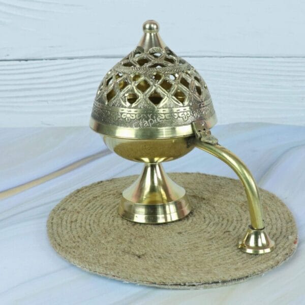 Side profile of the traditional brass incense censer, highlighting the elegant handle and pedestal base.