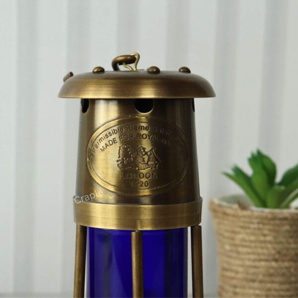 Brass Mariner’s Lantern-2 Close-up view of the antique brass finish and engraved plaque on the top section of the nautical oil lamp.