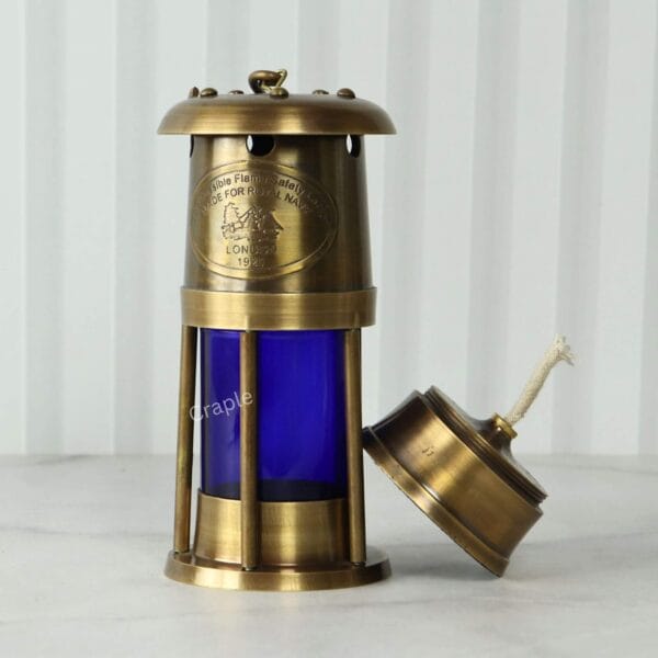 Brass Mariner’s Lantern-5 The removable brass oil burner leaning against the side of the blue lantern, showing the wick.