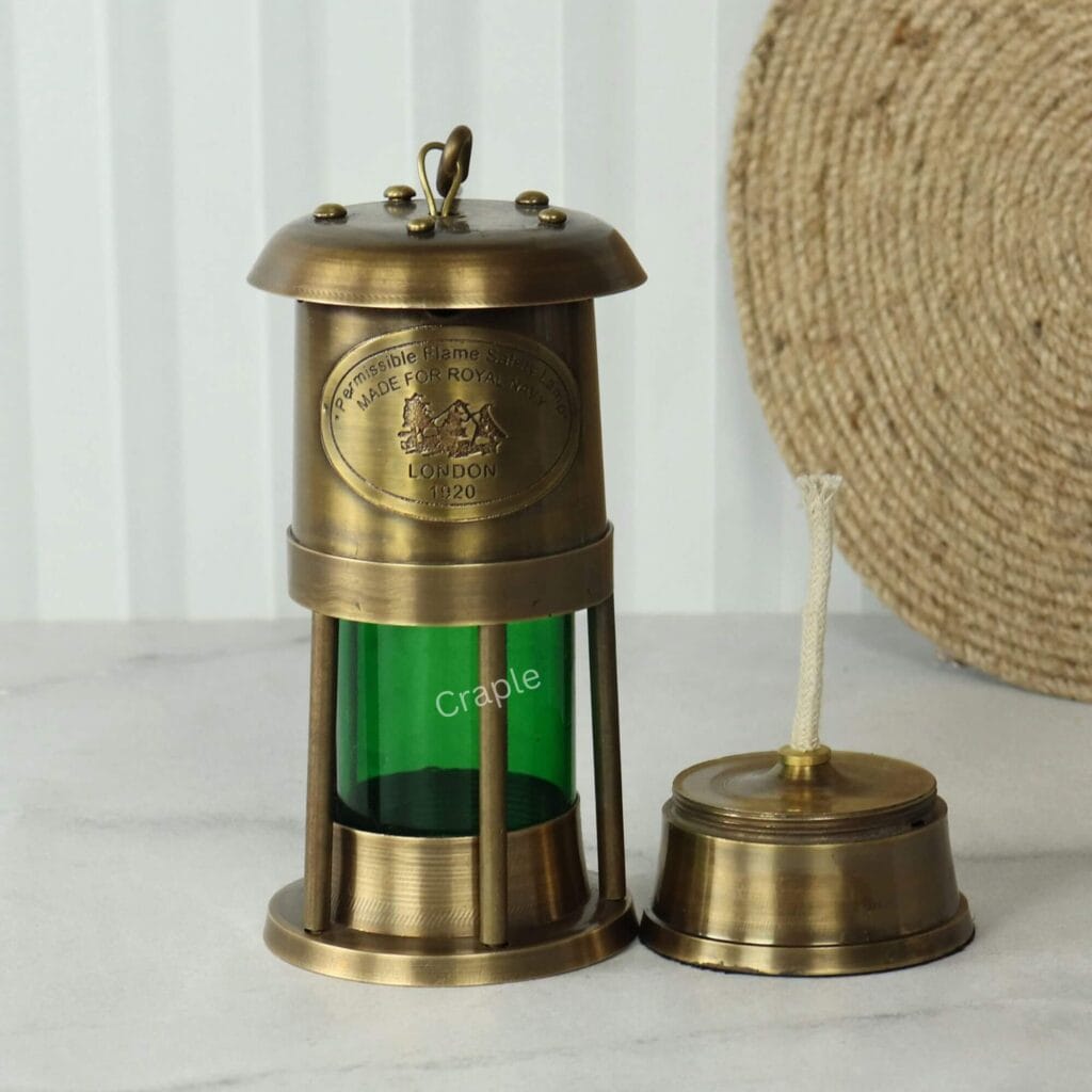 Brass nautical oil lamp with its oil burner and wick removed to display its functional parts.