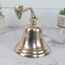 Wall-mounted solid brass nautical ship's bell with a shiny finish, complete with a traditional rope pull.