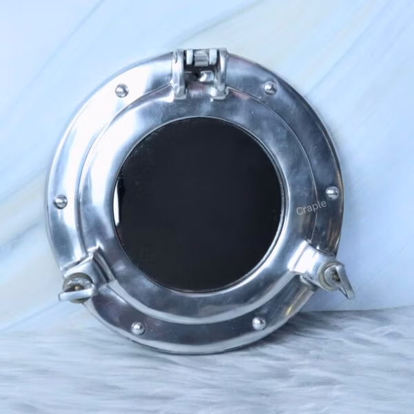 A round, nickel-finish porthole window frame shown in the open position against a wall.