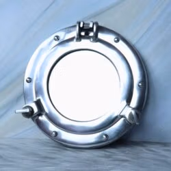 Front view of the round nautical porthole mirror in a closed position, showing the reflective glass.