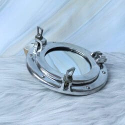 Ship's porthole mirror with a polished nickel finish, shown at an angle to highlight the side latches.