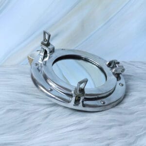 Ship's porthole mirror with a polished nickel finish, shown at an angle to highlight the side latches.
