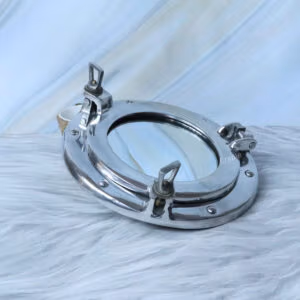 Ship's porthole mirror with a polished nickel finish, shown at an angle to highlight the side latches.