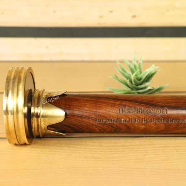 Detailed close-up on the polished wooden body and brass fittings of the classic optical kaleidoscope.