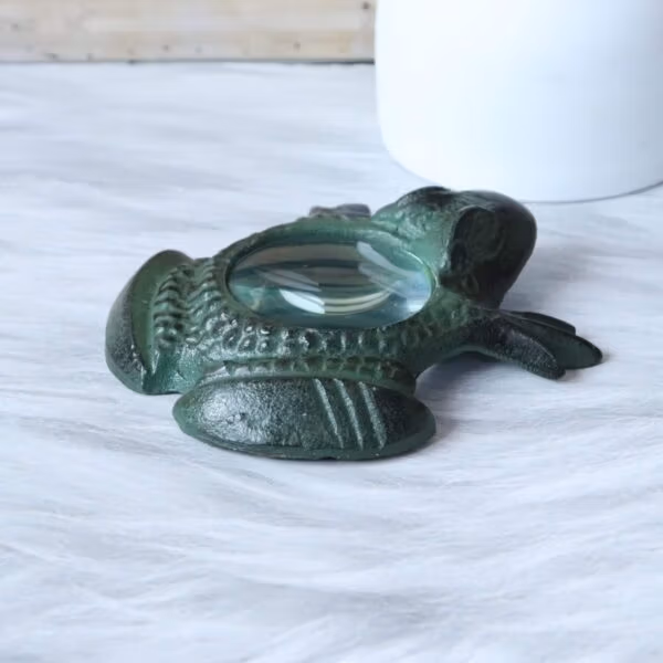 Frog Magnifying Glass-2 Side profile of the antique brass frog paperweight magnifier, showing its curved shape and three-dimensional details.