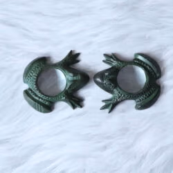 A pair of antique green brass frog magnifying glasses shown together from an angled view.