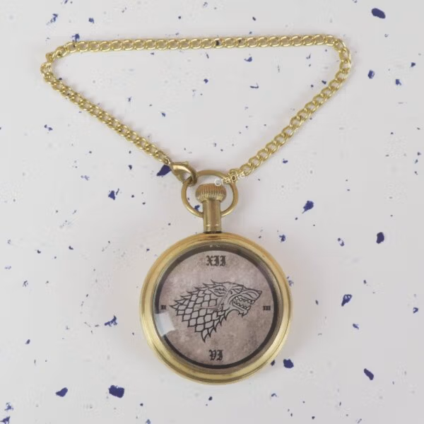 Game of Thrones pocket watch with the Direwolf sigil dial, hanging from its matching brass chain.