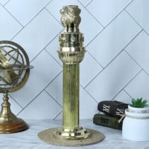Grand tall brass Ashoka Pillar sculpture displayed on a desk as a piece of heritage decor.