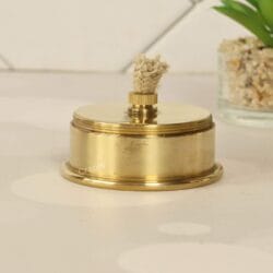 Close-up of the removable brass oil lamp burner, showing the adjustable cotton wick for the miner's lantern.