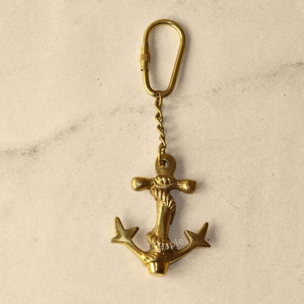 Handmade Anchor Rope Keychain-5 A flat lay of the entire brass anchor keychain, showing the anchor charm, link chain, and secure carabiner clip.