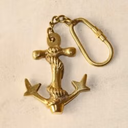 Close-up of the solid brass anchor charm, highlighting its sturdy construction and polished finish.