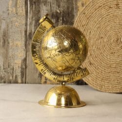 Handmade decorative desktop globe made of solid brass with a shiny finish, showing an engraved world map.