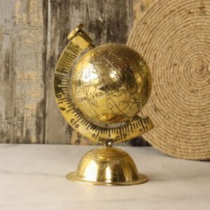 Handmade decorative desktop globe made of solid brass with a shiny finish, showing an engraved world map.