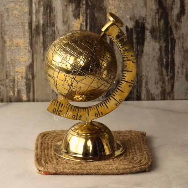Top-angled view of the collectible brass desktop globe with its engraved map detailing and sturdy base.