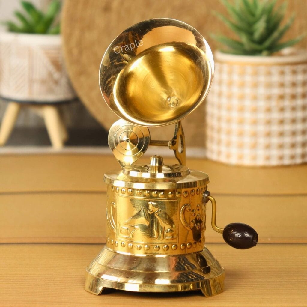 Handmade decorative brass gramophone with an ornate embossed base, classic horn, and a functional hand crank.