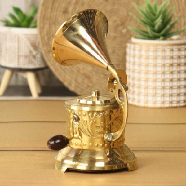 Angled view of the decorative brass miniature phonograph, highlighting its detachable morning glory horn.