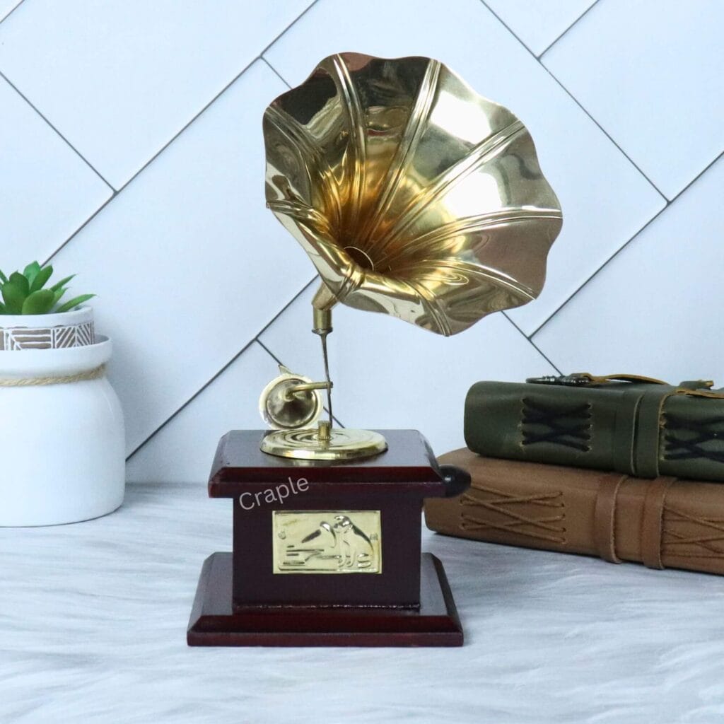 Handmade decorative gramophone with a shiny brass horn and a dark stained wood base, used as a vintage home decor piece