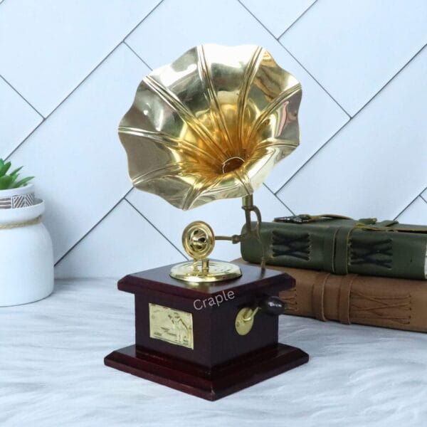 Front-angled view of the tabletop brass and wood gramophone display piece.