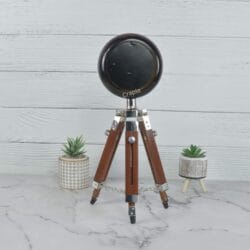 Rear view of the handmade tripod table clock, showcasing the solid construction of the clock head and stand.