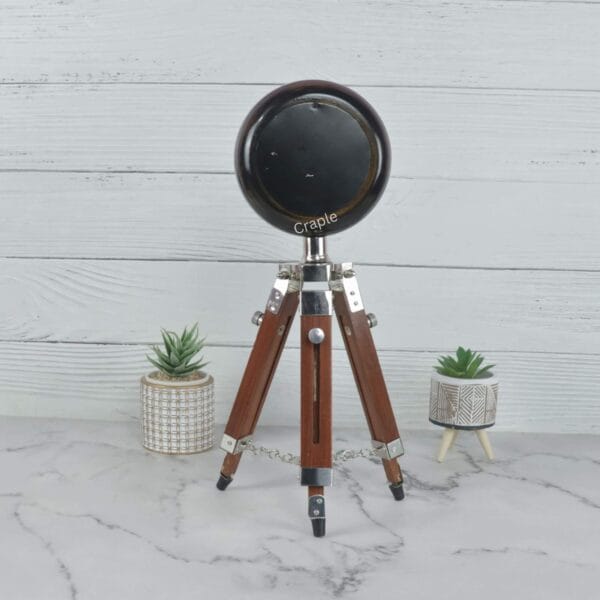 Rear view of the handmade tripod table clock, showcasing the solid construction of the clock head and stand.