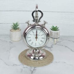 Front view of a vintage stopwatch-style hanging desk clock with a nickel finish, Roman numerals, and a sturdy base.