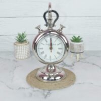 The nickel-plated aluminum stopwatch clock displayed as a decorative piece between two small potted succulents.